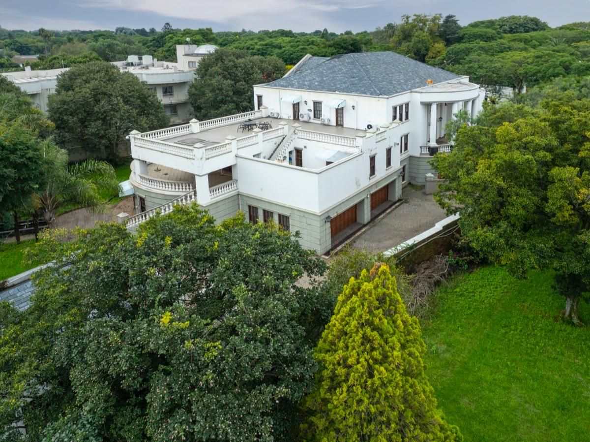 The 5 Saxonwold Drive mansion with its beautifully painted white walls surrounded by green trees, keeping you closer to nature.